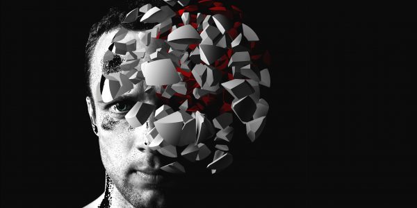 Caucasian man creative portrait with 3d explosion fragments on black background